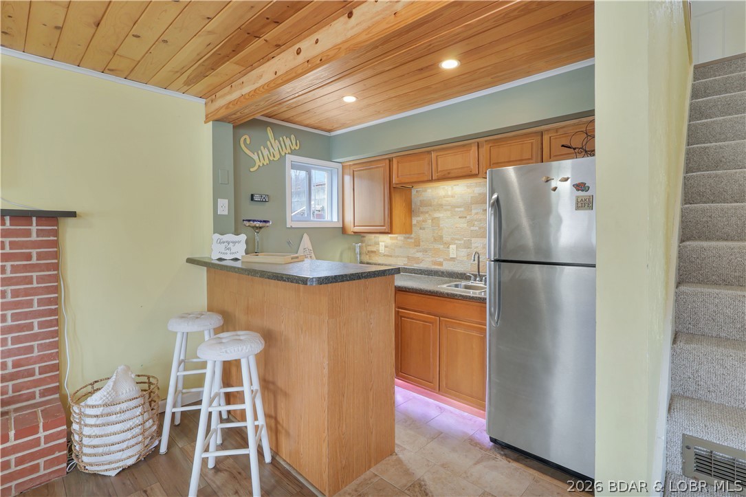 29966 Oak Knoll Road Rocky Mount, MO 65072 - Photo 8 of 59 Wet bar area features a tile floor, under-cabinet