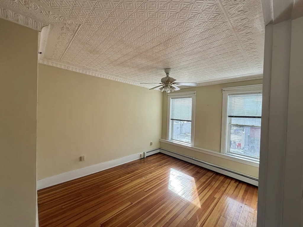 27 High Street, Unit 1 Clinton, MA 01510 - Photo 8 of 30 a view of empty room with wooden floor and fan
