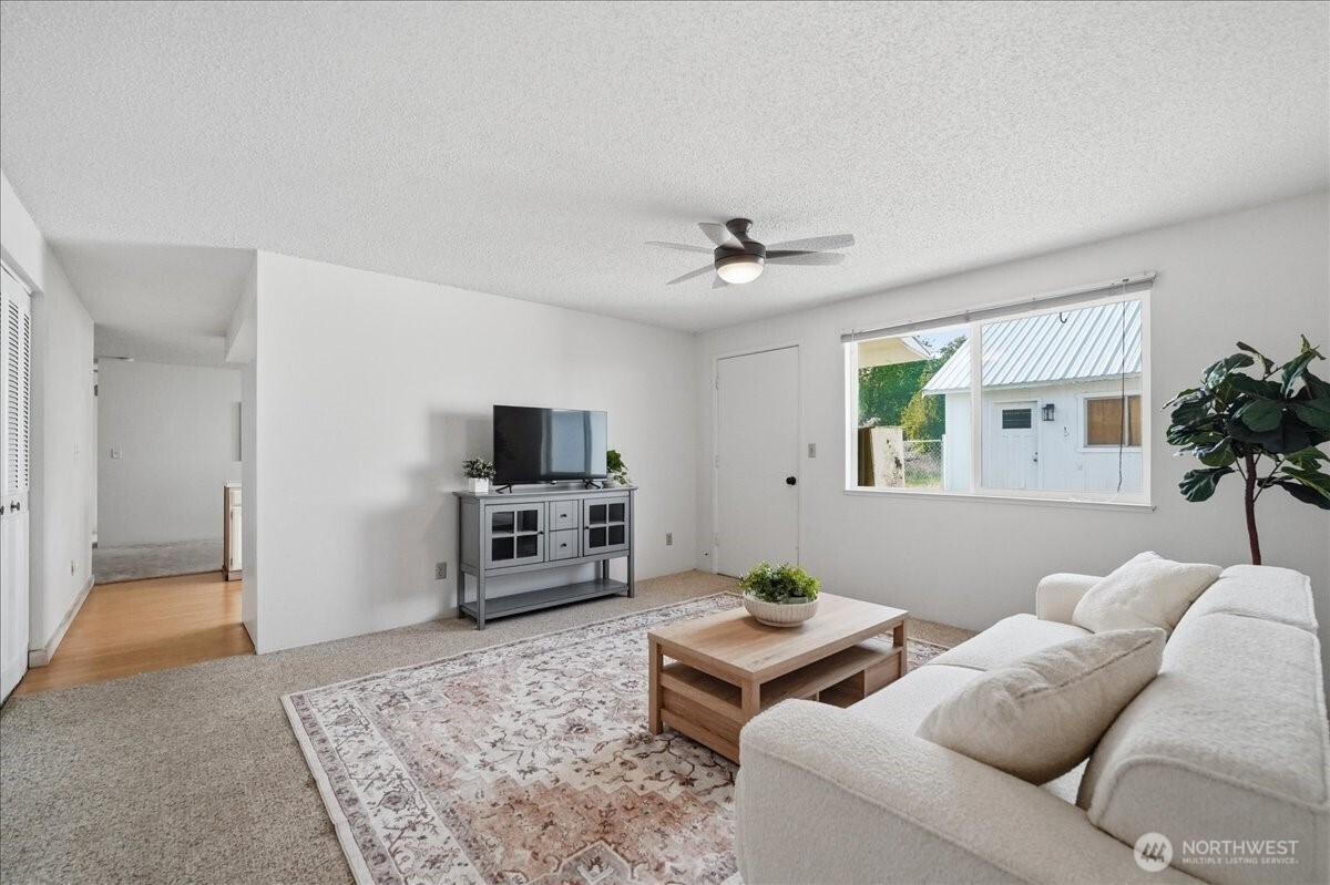 309 West Walnut Street Waterville, WA 98858 - Photo 15 of 28 a living room with furniture and a flat screen tv