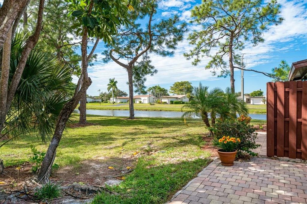 2009 Pine Isle Lane, Unit 2009 Naples, FL 34112 - Photo 1 of 33 a view of a garden with large trees