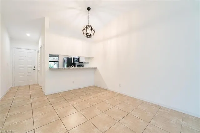 an empty room with fan and entrance