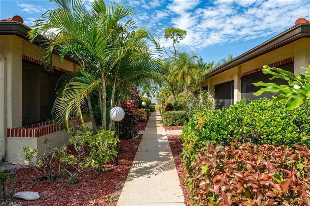 2009 Pine Isle Lane, Unit 2009 Naples, FL 34112 - Photo 25 of 33 a view of a backyard with plants