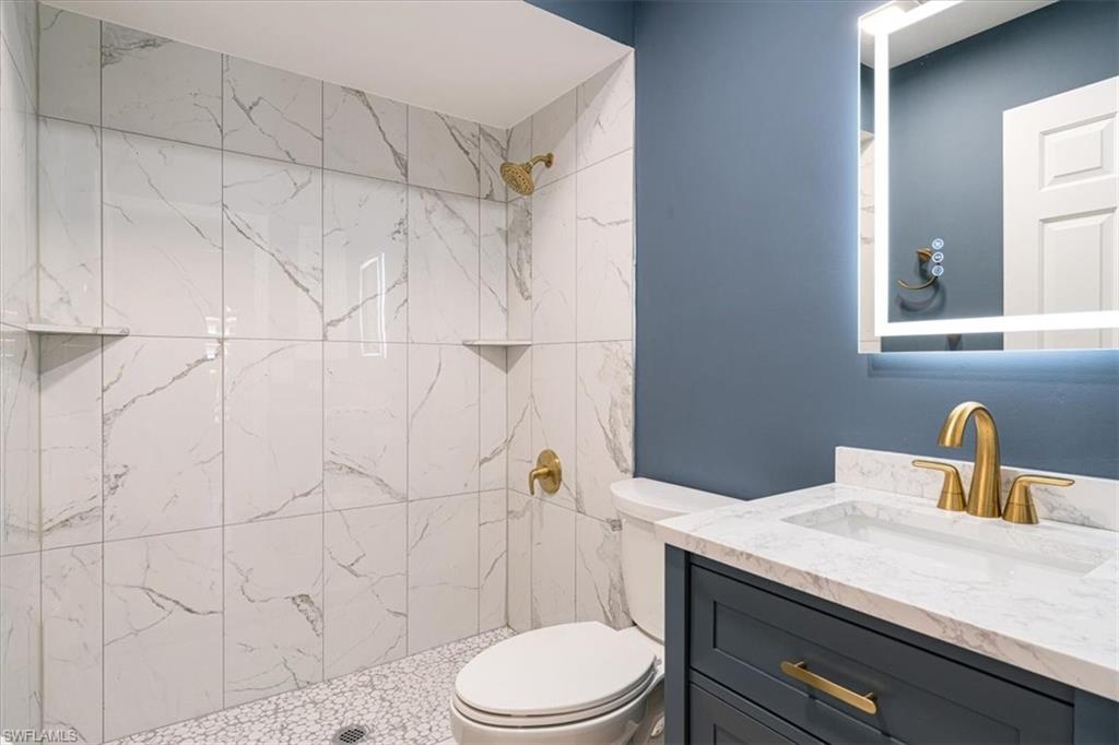 2009 Pine Isle Lane, Unit 2009 Naples, FL 34112 - Photo 7 of 33 a bathroom with a sink a toilet and shower