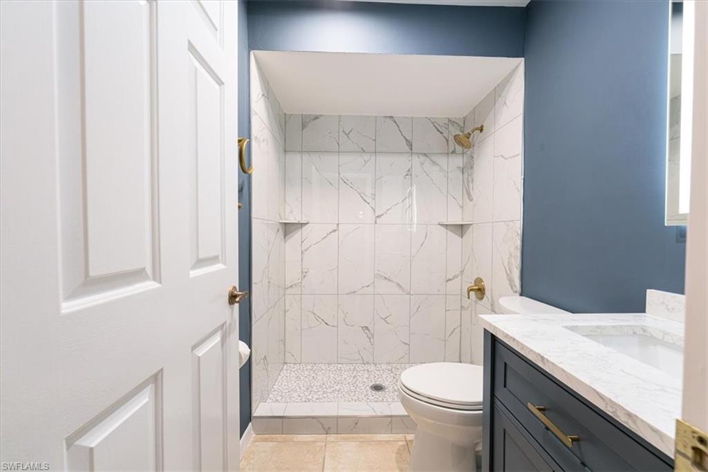 2009 Pine Isle Lane, Unit 2009 Naples, FL 34112 - Photo 8 of 33 a bathroom with a sink a toilet and shower