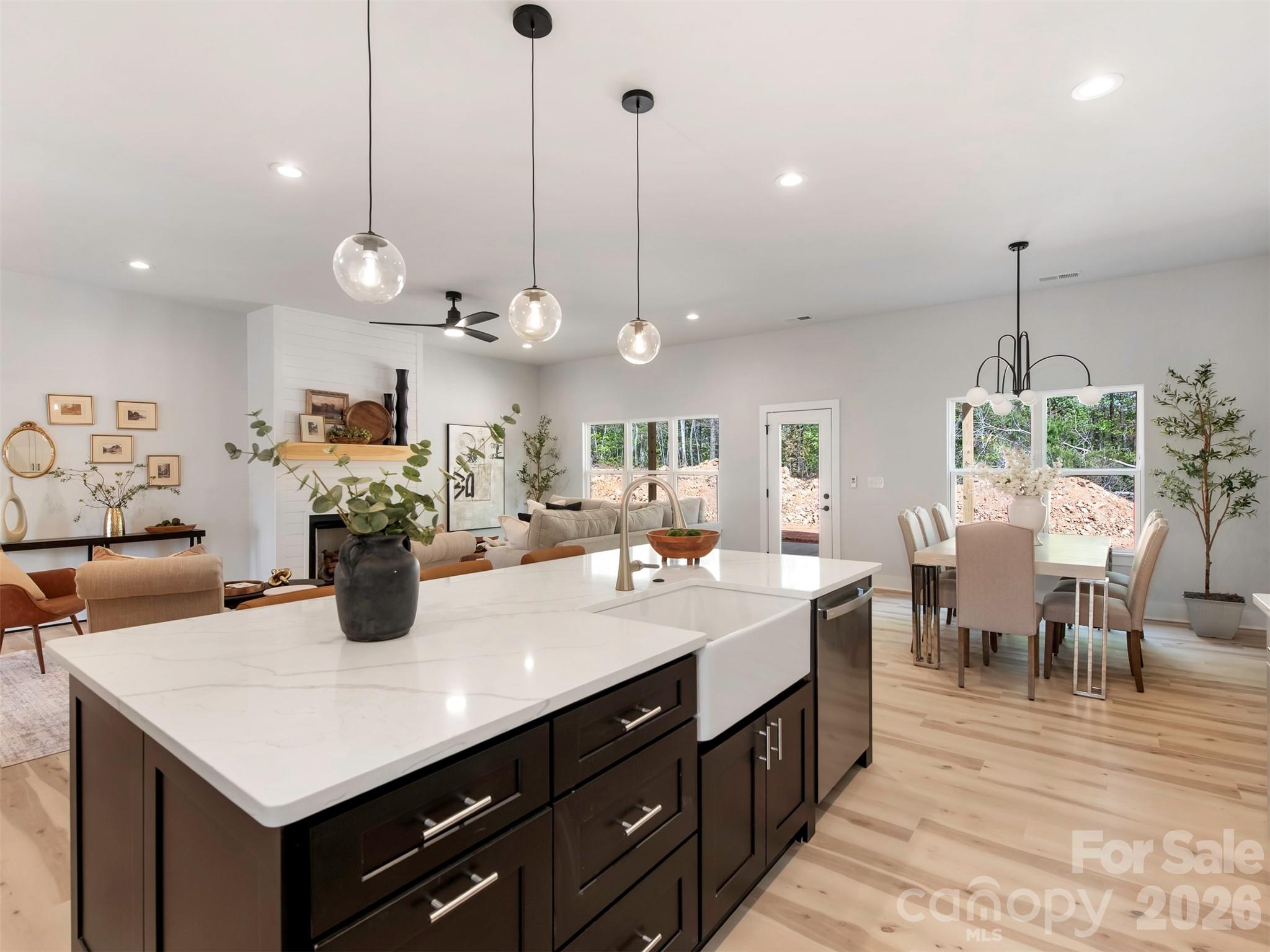 12133 Coyle Road Stanfield, NC 28163 - Photo 12 of 43 a kitchen with kitchen island a dining table and chairs