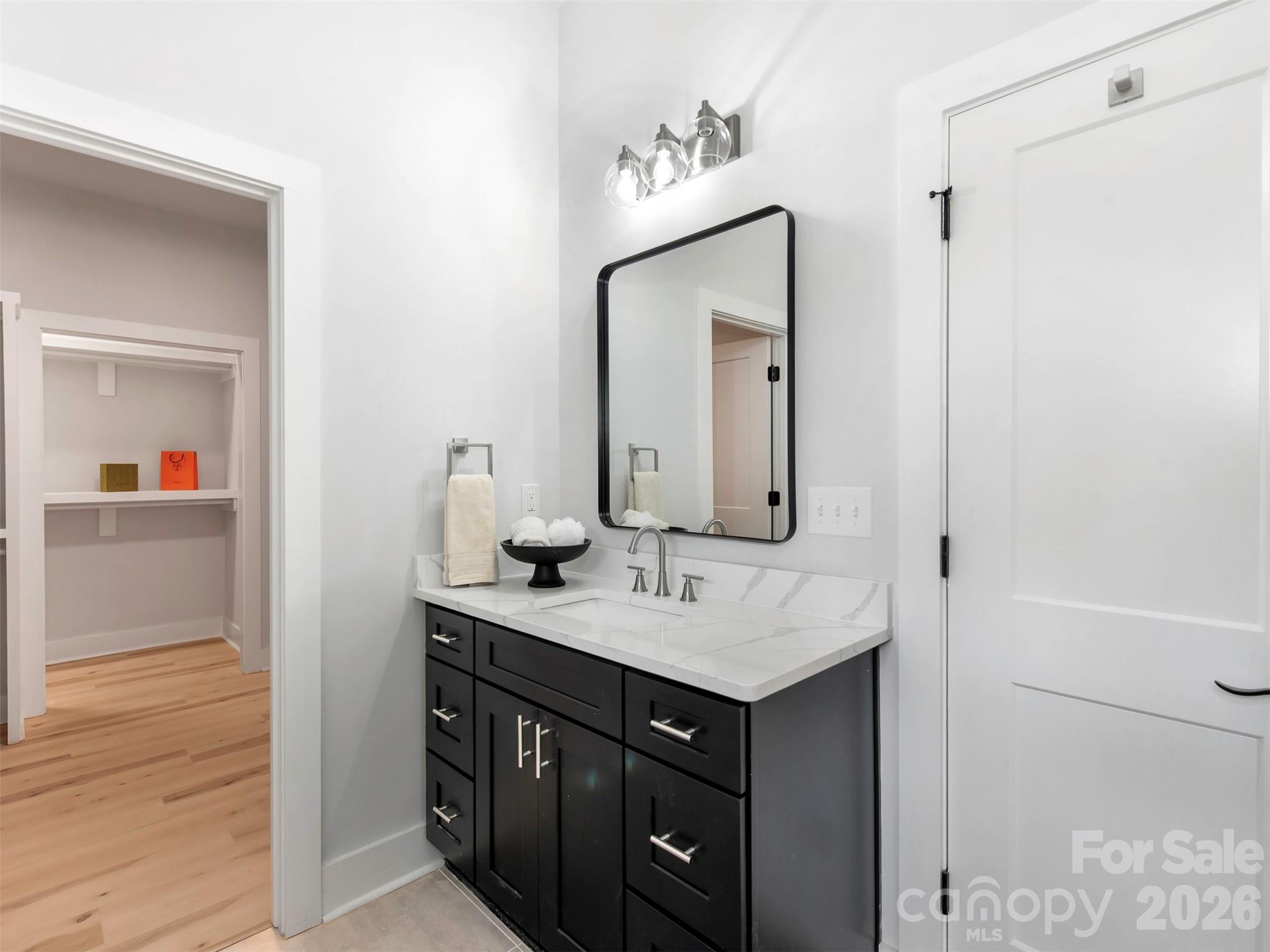 12133 Coyle Road Stanfield, NC 28163 - Photo 20 of 43 a bathroom with a sink vanity and a mirror