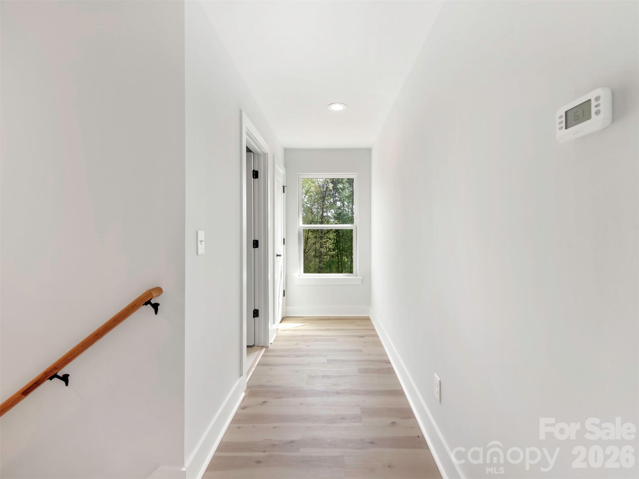 12133 Coyle Road Stanfield, NC 28163 - Photo 28 of 43 a view of a hallway with wooden floor and a window