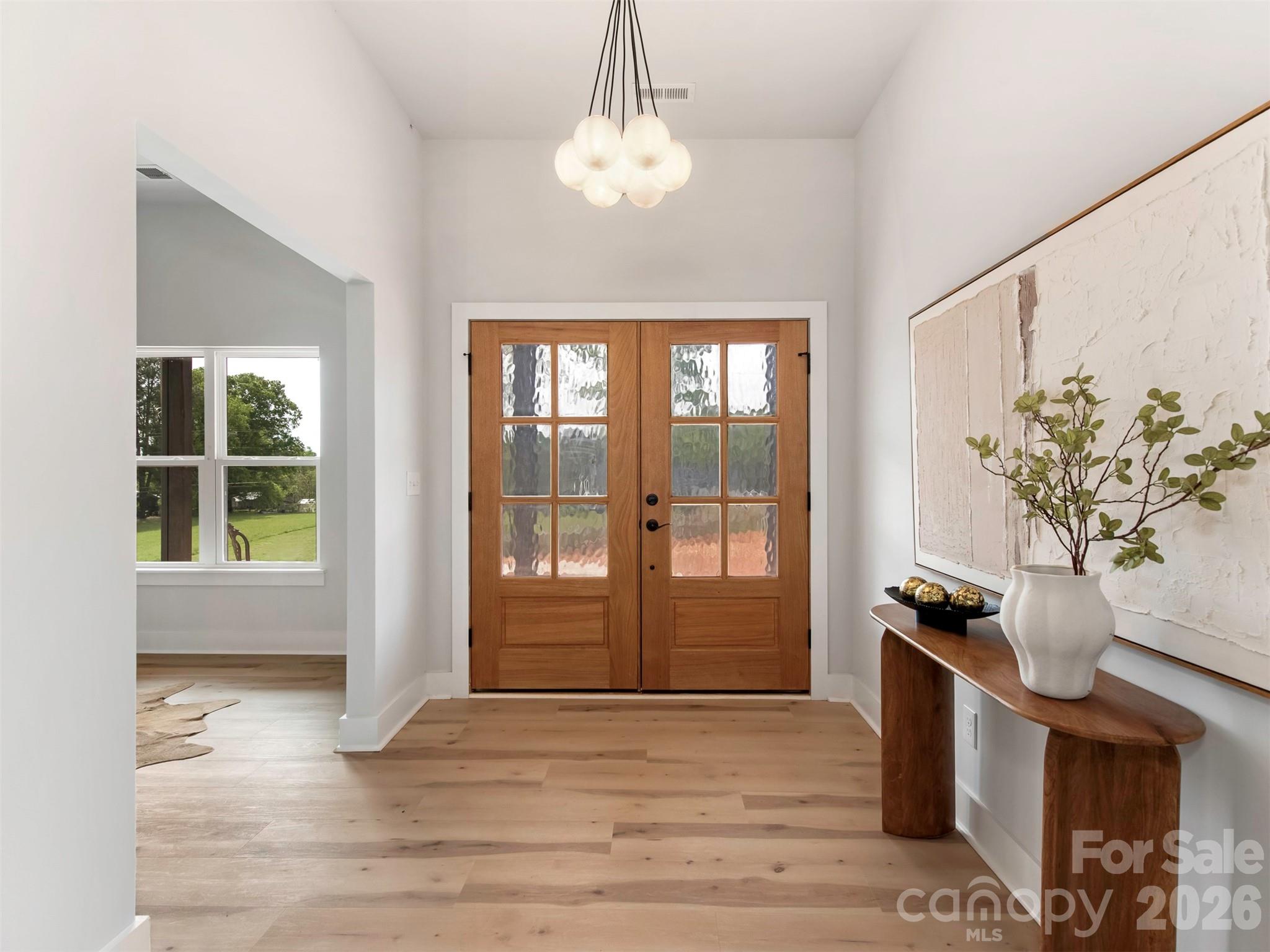 12133 Coyle Road Stanfield, NC 28163 - Photo 3 of 43 a view of livingroom with furniture wooden floor and a chandelier
