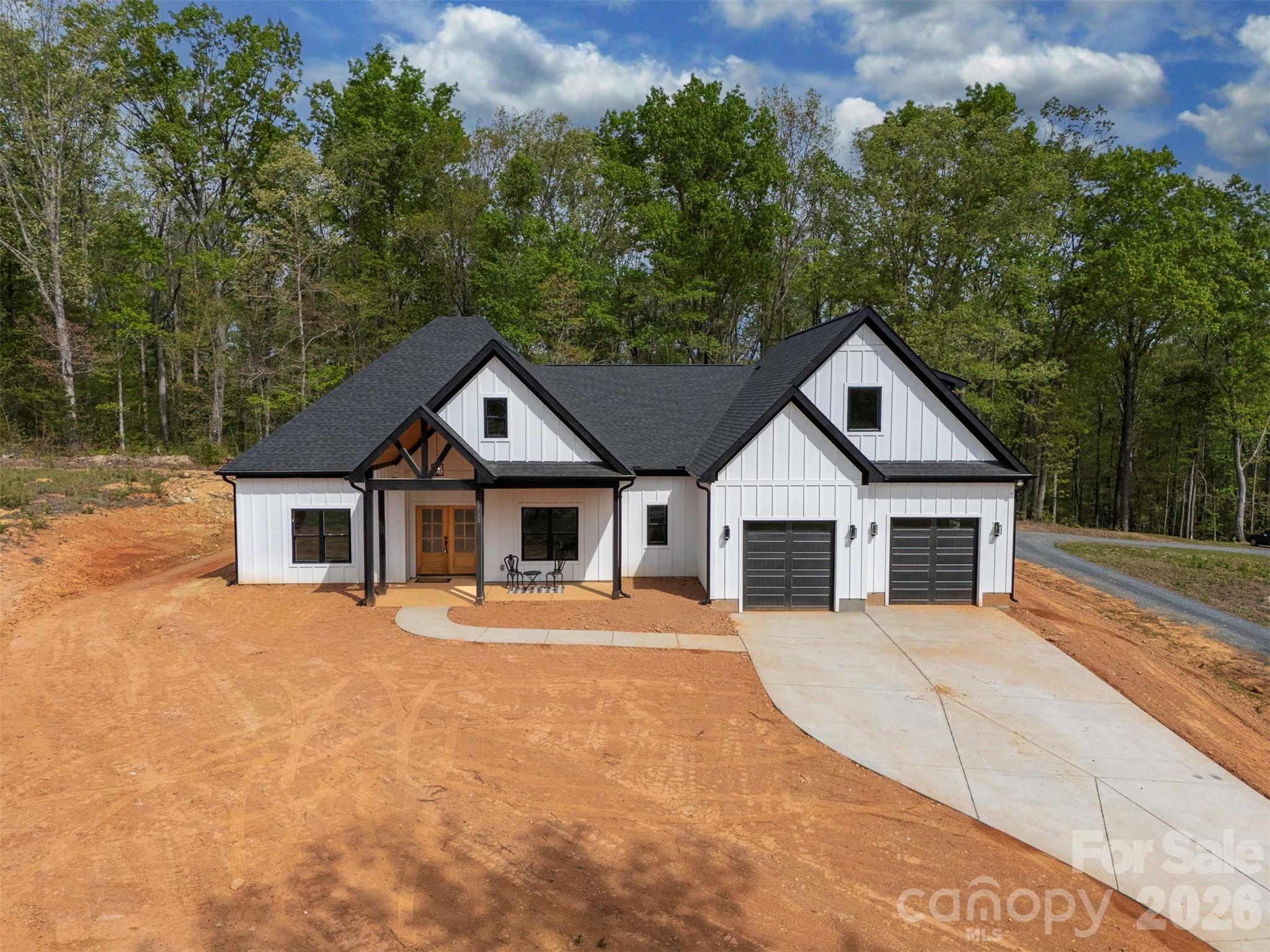12133 Coyle Road Stanfield, NC 28163 - Photo 40 of 43 a view of a house with yard and large trees