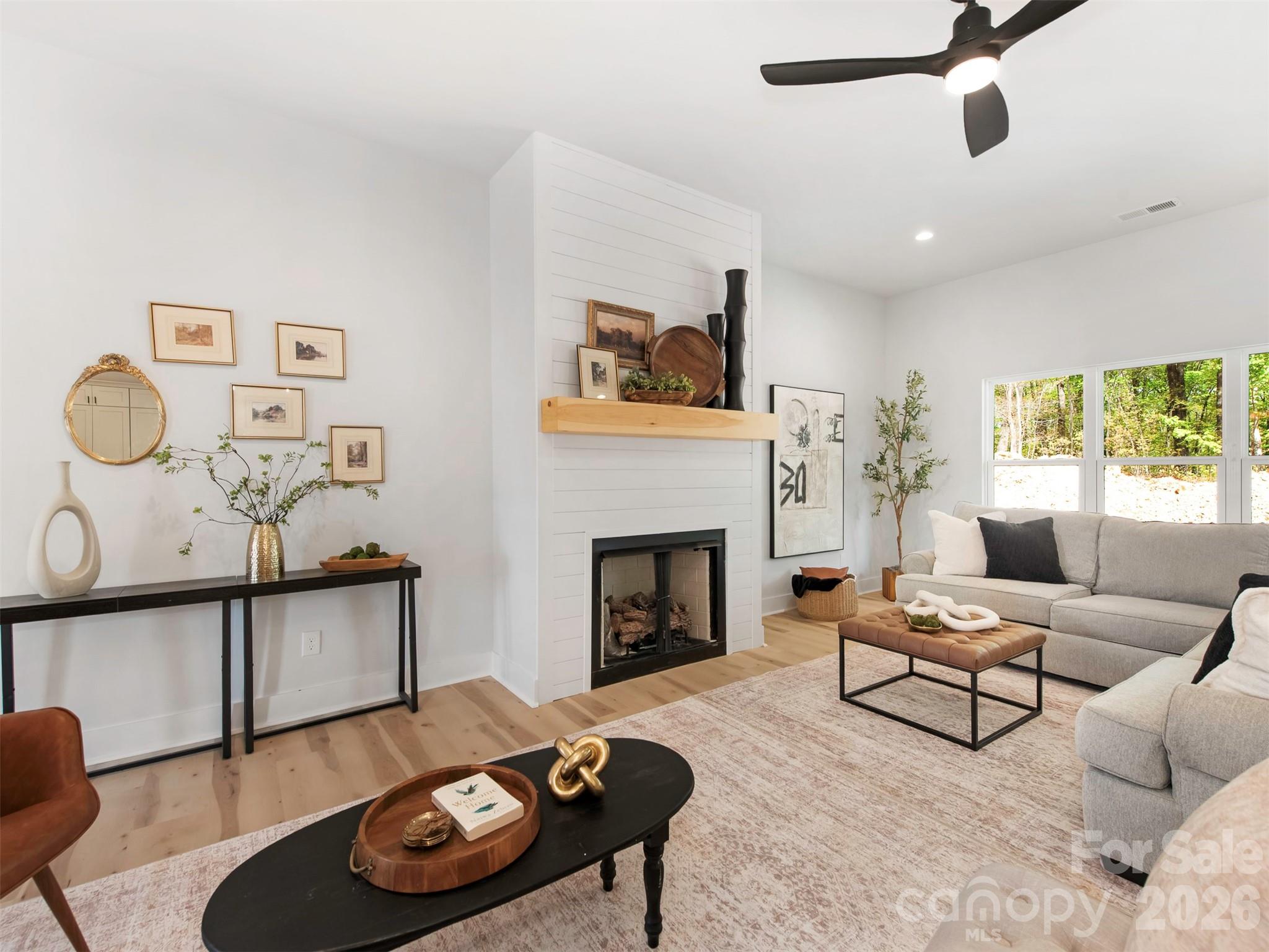 12133 Coyle Road Stanfield, NC 28163 - Photo 6 of 43 a living room with furniture and a fireplace
