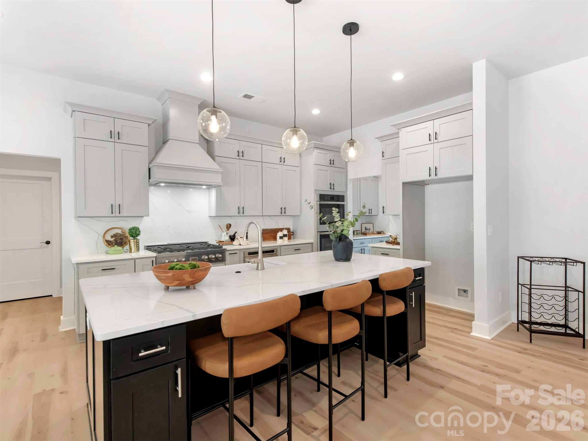 12133 Coyle Road Stanfield, NC 28163 - Photo 10 of 43 a kitchen with a dining table chairs sink and cabinets