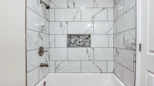 a bathroom with a bathtub and shower