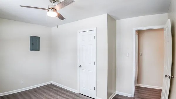 a view of an empty room with wooden floor
