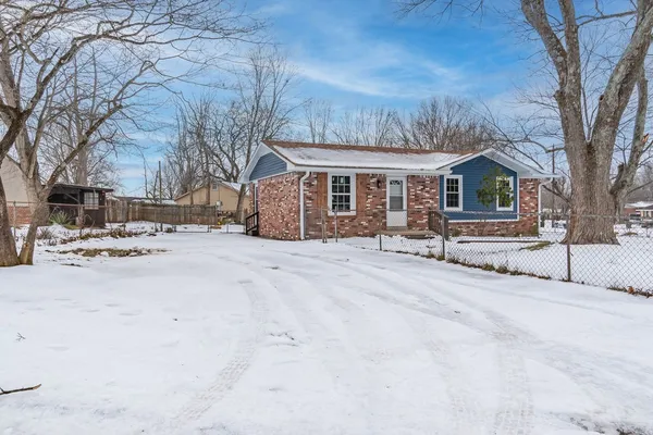 a view of house with a yard covered in snow