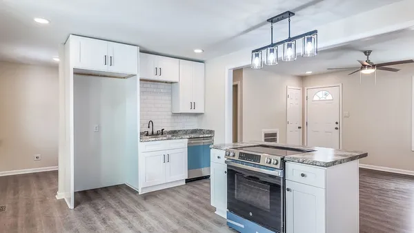 a kitchen with stainless steel appliances granite countertop a stove and a refrigerator