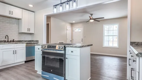 a kitchen with a stove oven and sink