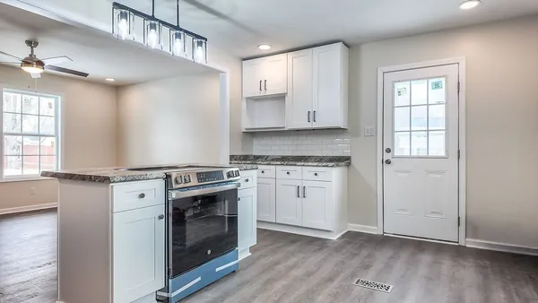 a kitchen with a stove oven and sink