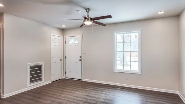 wooden floor in an empty room with a window