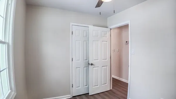 a view of a hallway with wooden floor