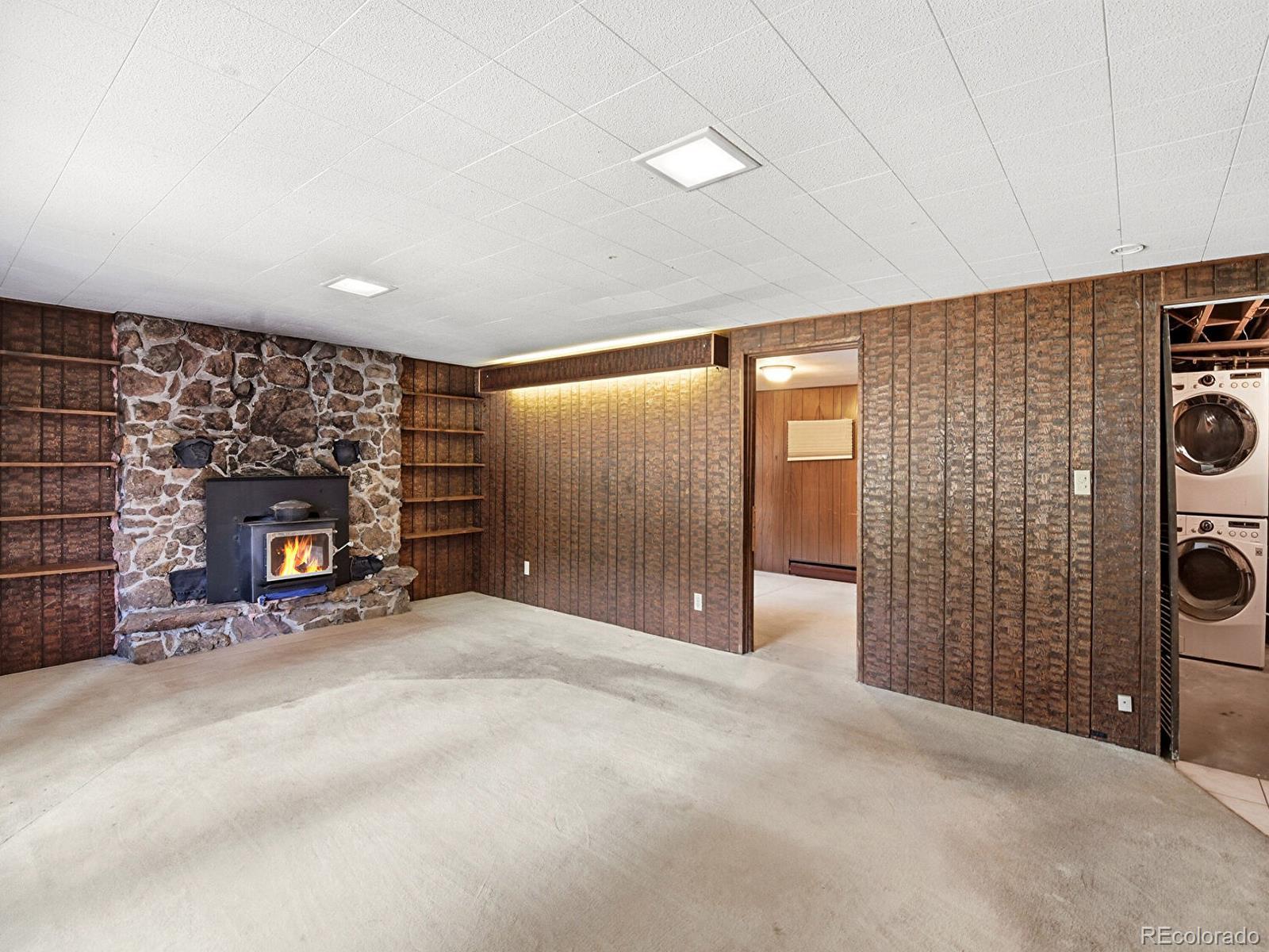 2830 Kerr Gulch Road Evergreen, CO 80439 - Photo 29 of 48 a view of an empty room with a fireplace