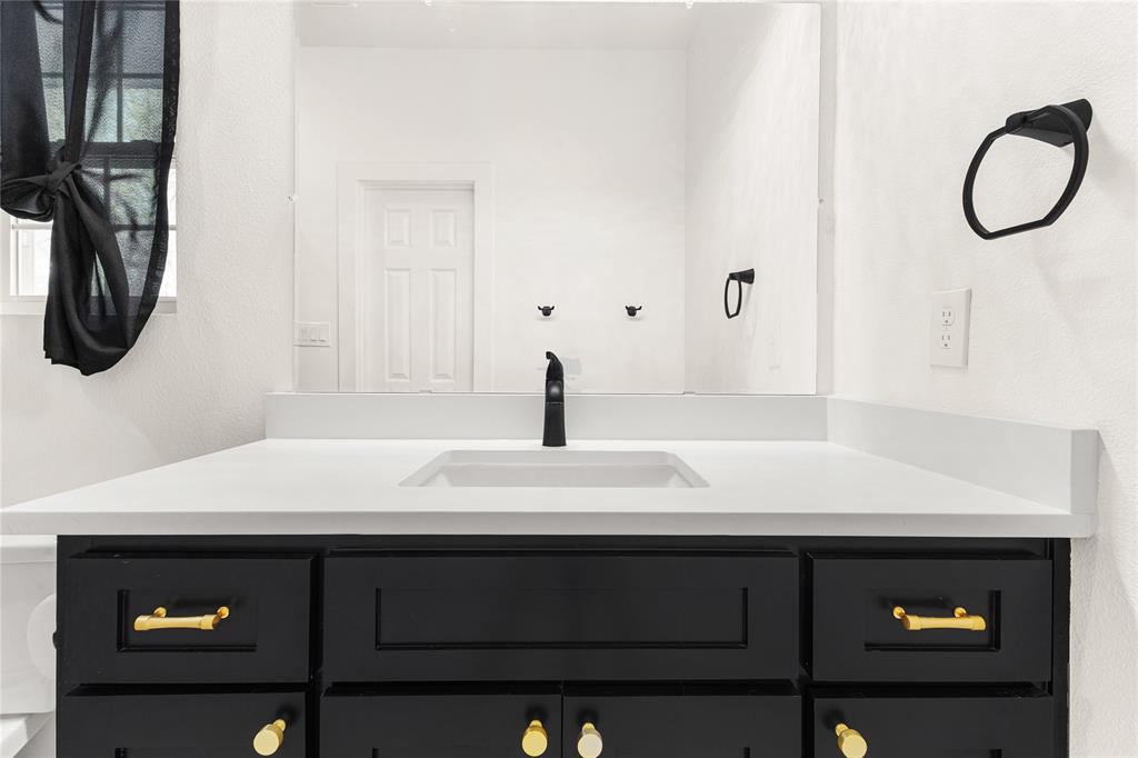 101 Ross Street Sulphur Springs, TX 75482 - Photo 14 of 29 a bathroom with a sink and a mirror
