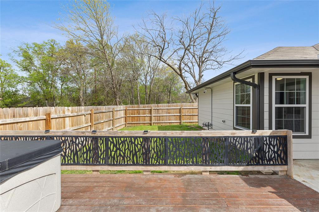 101 Ross Street Sulphur Springs, TX 75482 - Photo 24 of 29 a view of a balcony with a floor to ceiling window and wooden fence