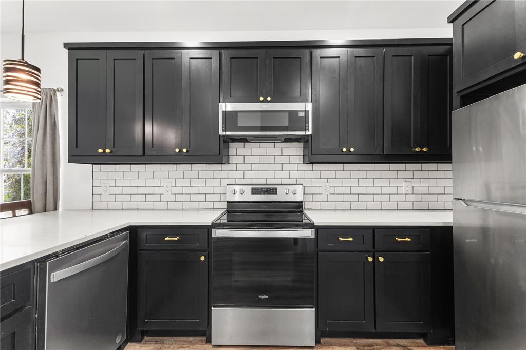 101 Ross Street Sulphur Springs, TX 75482 - Photo 8 of 29 a kitchen with granite countertop a sink and cabinets