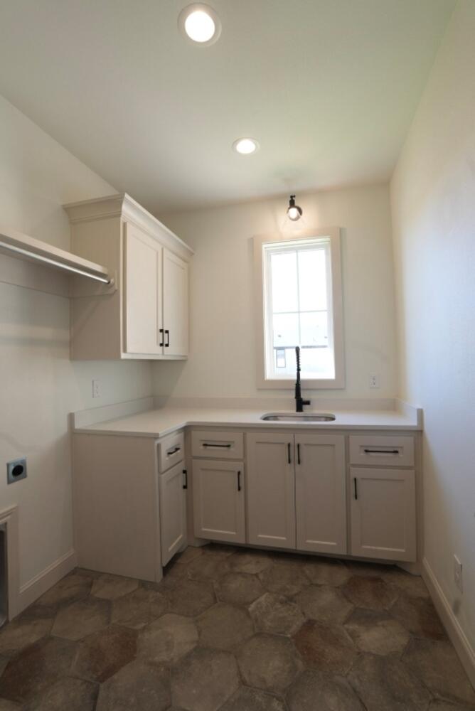 4620 143rd Street Lubbock, TX 79424 - Photo 12 of 25 a spacious bathroom with a sink and a window