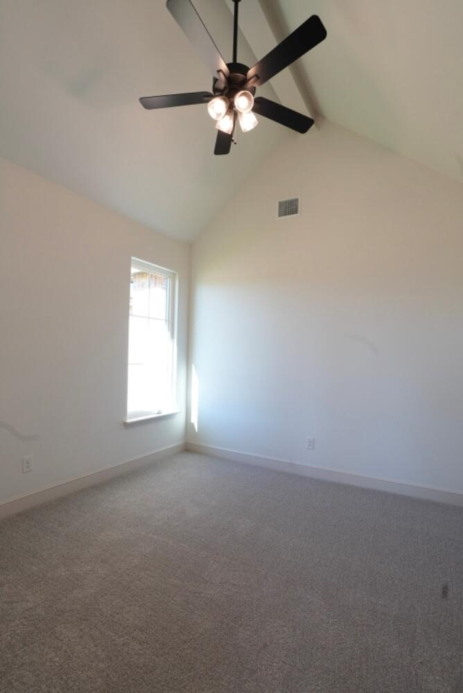 4620 143rd Street Lubbock, TX 79424 - Photo 13 of 25 an empty room with a window and a fan