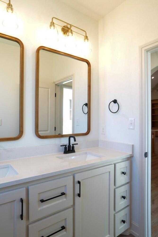 4620 143rd Street Lubbock, TX 79424 - Photo 14 of 25 a bathroom with a sink and a mirror