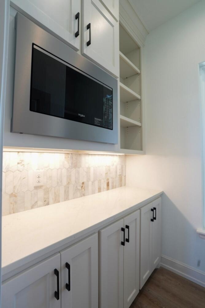 4620 143rd Street Lubbock, TX 79424 - Photo 17 of 25 a kitchen with a sink and a microwave
