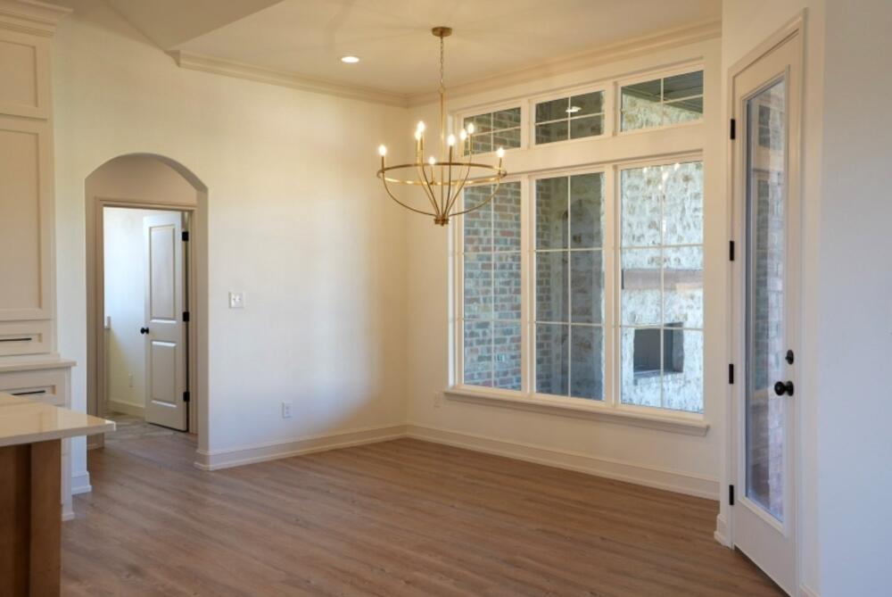 4620 143rd Street Lubbock, TX 79424 - Photo 18 of 25 a view of an empty room with wooden floor and a window