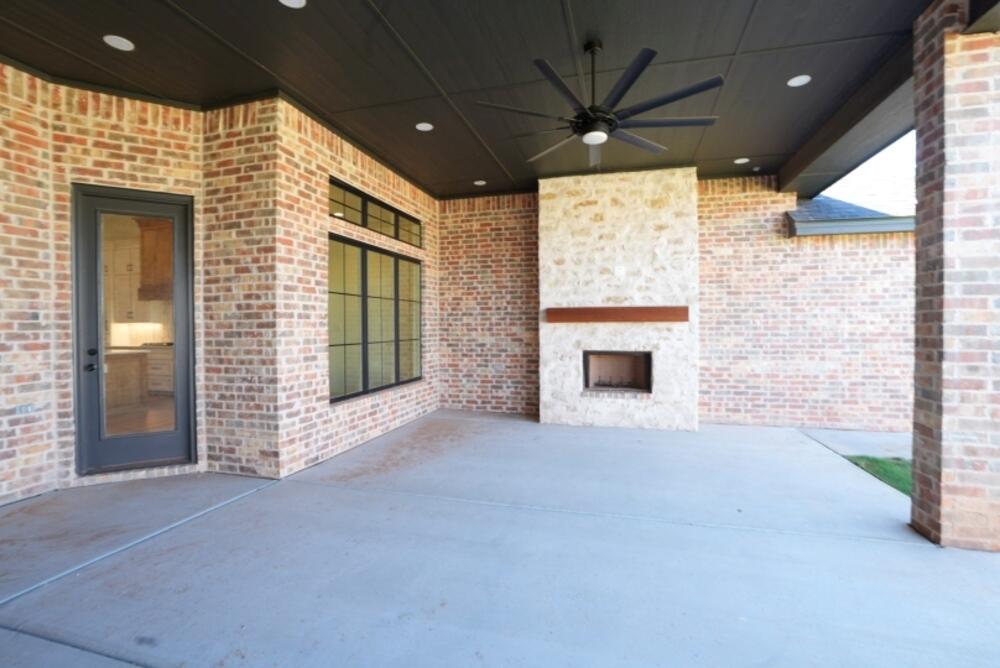 4620 143rd Street Lubbock, TX 79424 - Photo 22 of 25 a view of an empty room with a fireplace and a window
