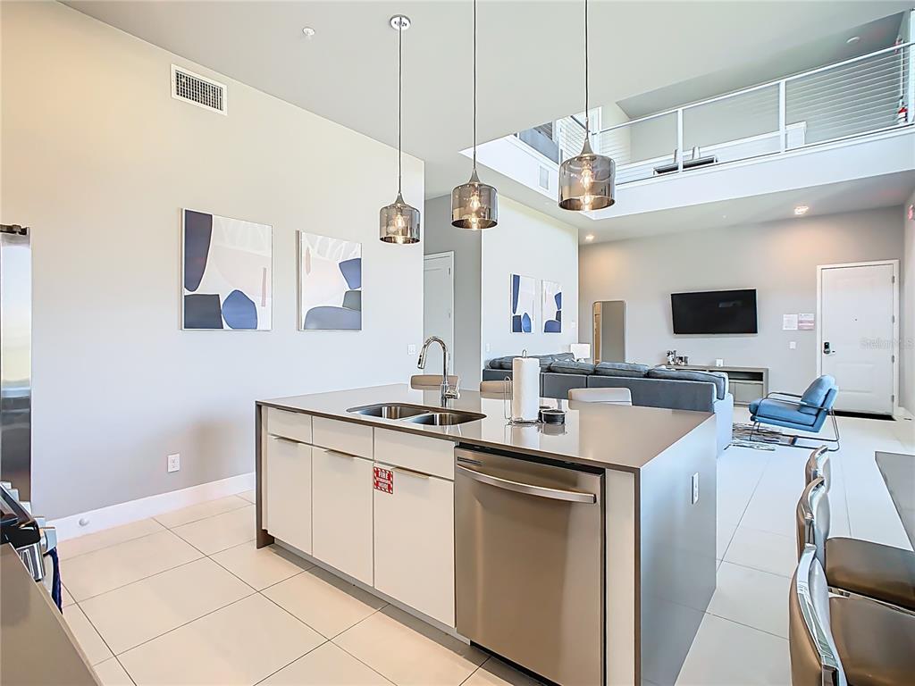 7740 Sandy Ridge Drive, Unit 245 Reunion, FL 34747 - Photo 12 of 57 a kitchen with a sink a counter top space appliances and cabinets