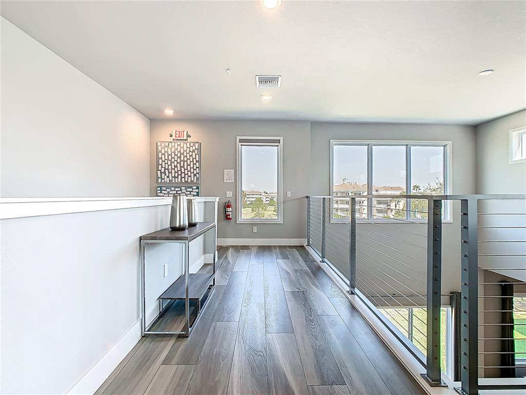 7740 Sandy Ridge Drive, Unit 245 Reunion, FL 34747 - Photo 20 of 57 a view of a living room hardwood floor and a kitchen