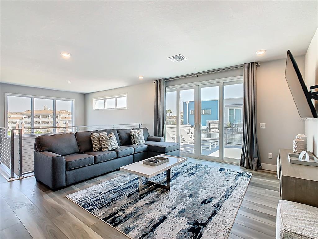 7740 Sandy Ridge Drive, Unit 245 Reunion, FL 34747 - Photo 22 of 57 a living room with furniture and a rug