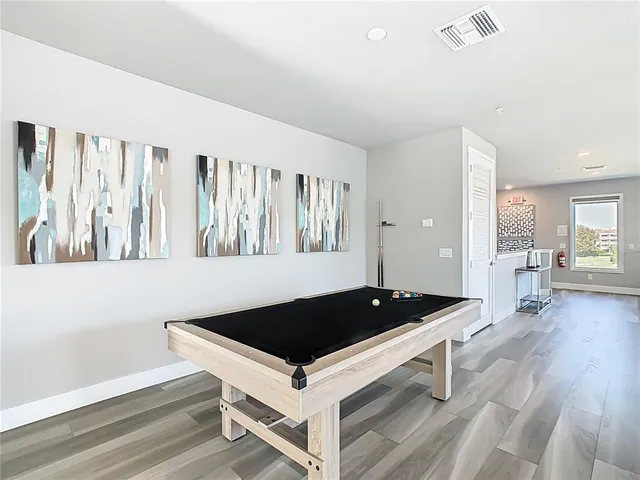 a bedroom with two beds and painting on the wall