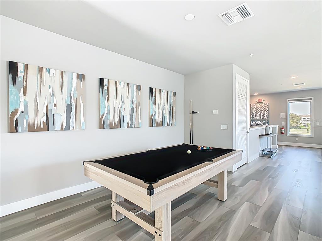 7740 Sandy Ridge Drive, Unit 245 Reunion, FL 34747 - Photo 24 of 57 a living room with furniture a table and wooden floor