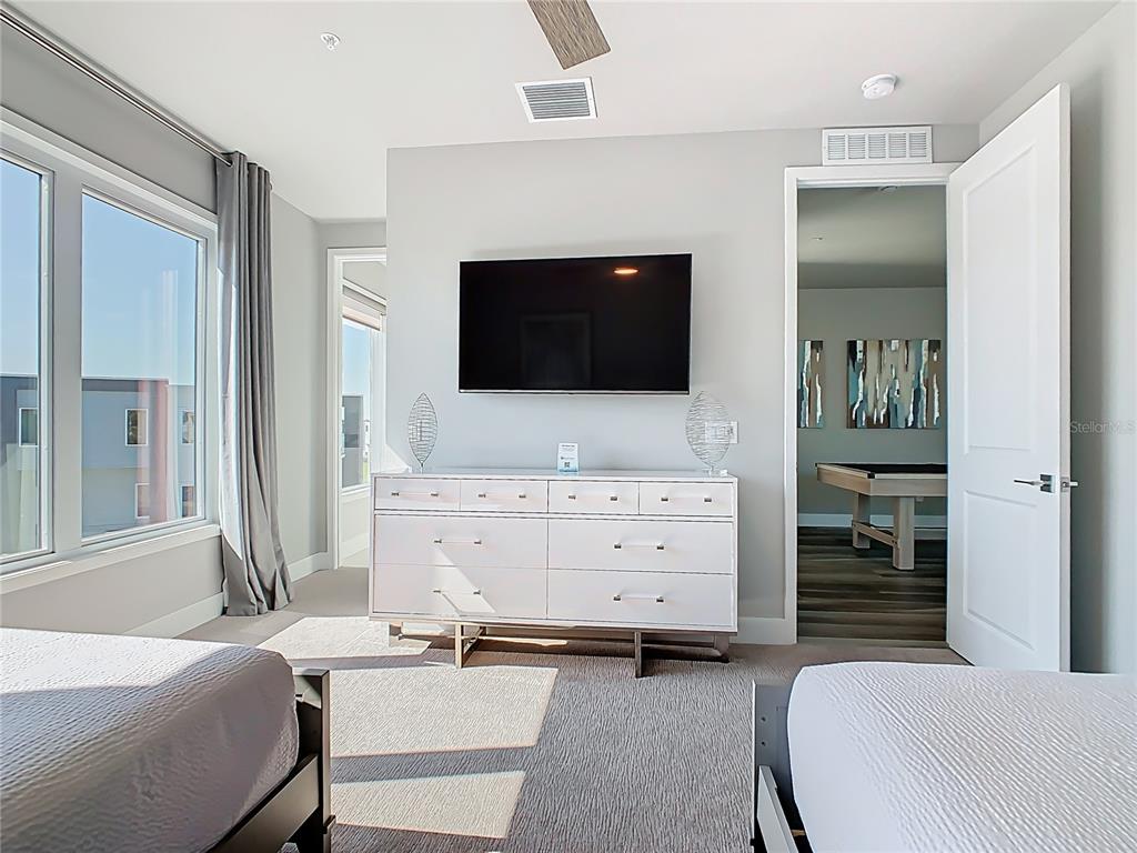 7740 Sandy Ridge Drive, Unit 245 Reunion, FL 34747 - Photo 28 of 57 a room with furniture and a flat screen tv