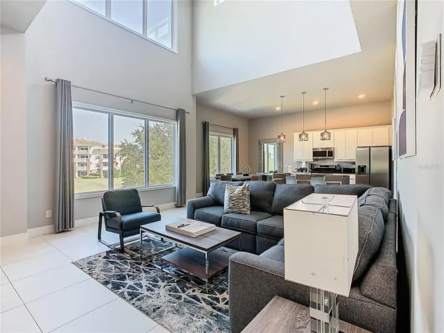 a living room with furniture and view of kitchen