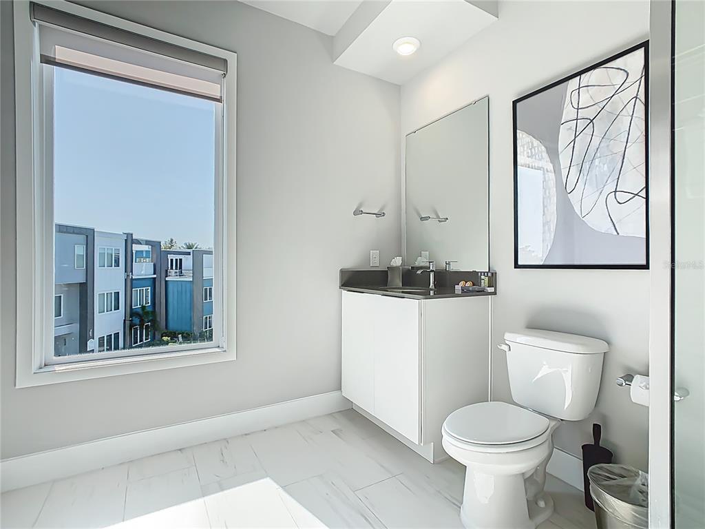 7740 Sandy Ridge Drive, Unit 245 Reunion, FL 34747 - Photo 31 of 57 a bathroom with a toilet sink and mirror