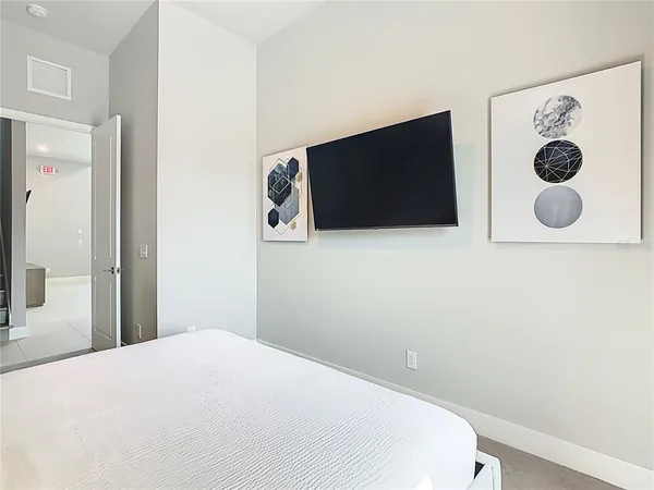 a bedroom with a large bed and a large window