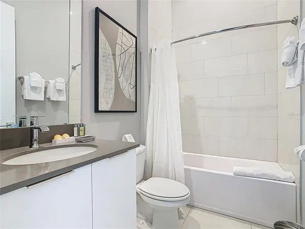 a bedroom with a bed and a flat tv screen