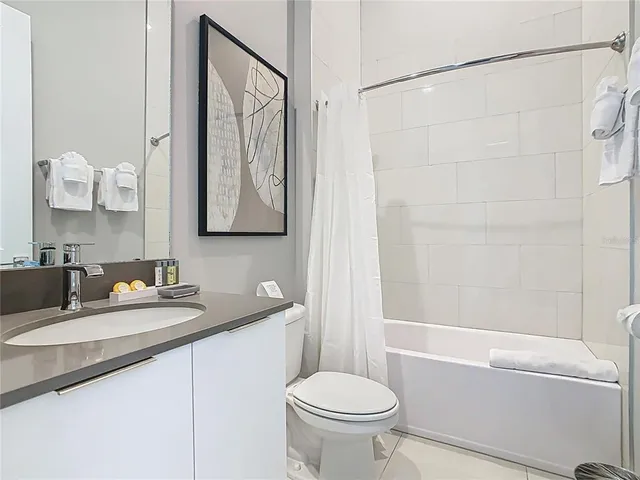 a bedroom with a bed and a flat tv screen