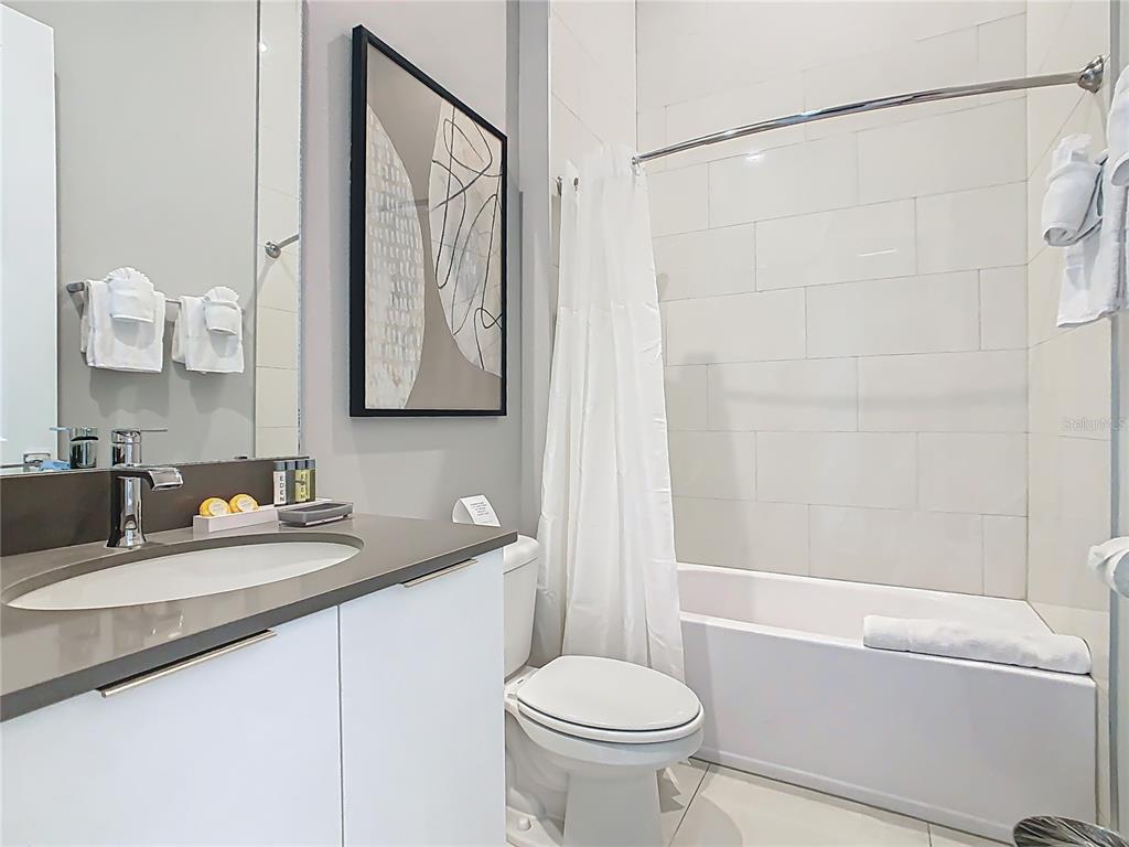 7740 Sandy Ridge Drive, Unit 245 Reunion, FL 34747 - Photo 36 of 57 a bathroom with a granite countertop sink toilet and shower