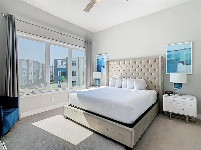 a bedroom with a bed and a large window