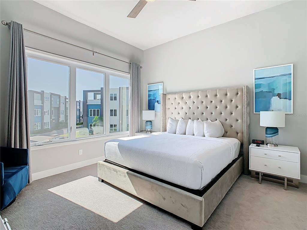 7740 Sandy Ridge Drive, Unit 245 Reunion, FL 34747 - Photo 37 of 57 a bedroom with a large bed and a large window