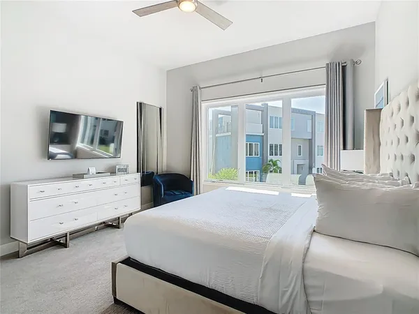 a bedroom with a bed and a painting on the wall