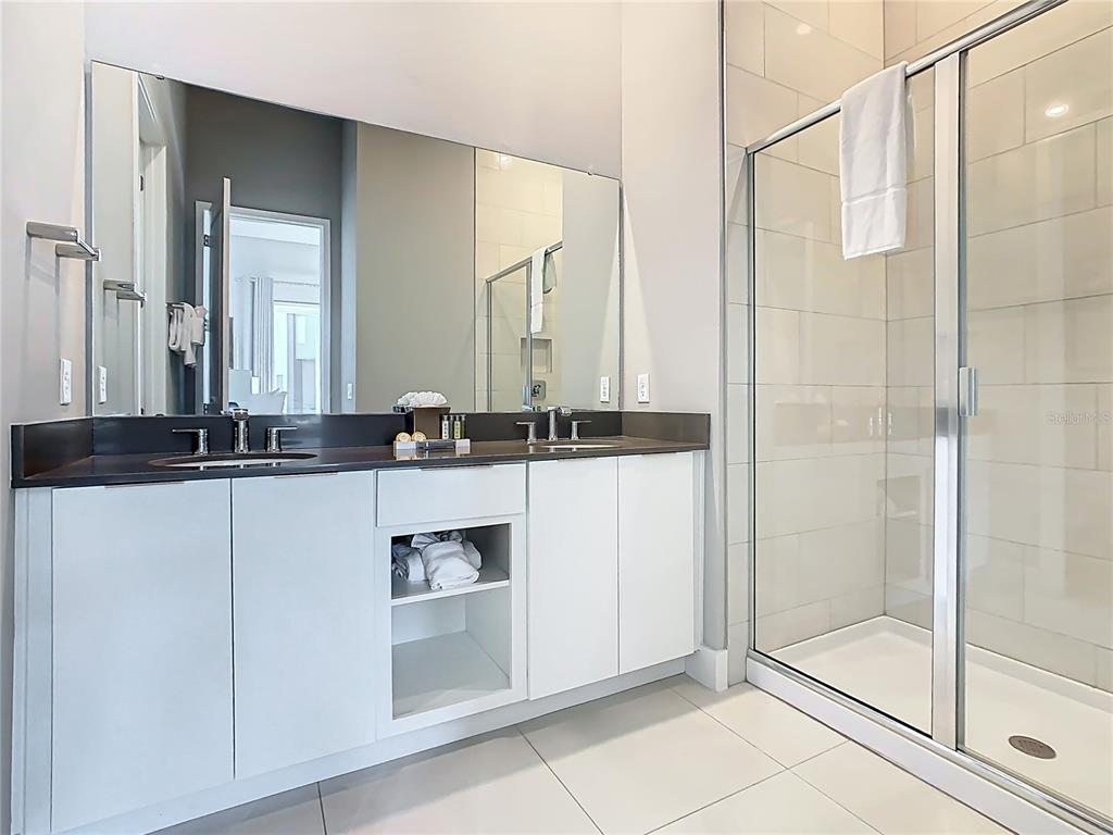 7740 Sandy Ridge Drive, Unit 245 Reunion, FL 34747 - Photo 40 of 57 a bathroom with a sink and a mirror