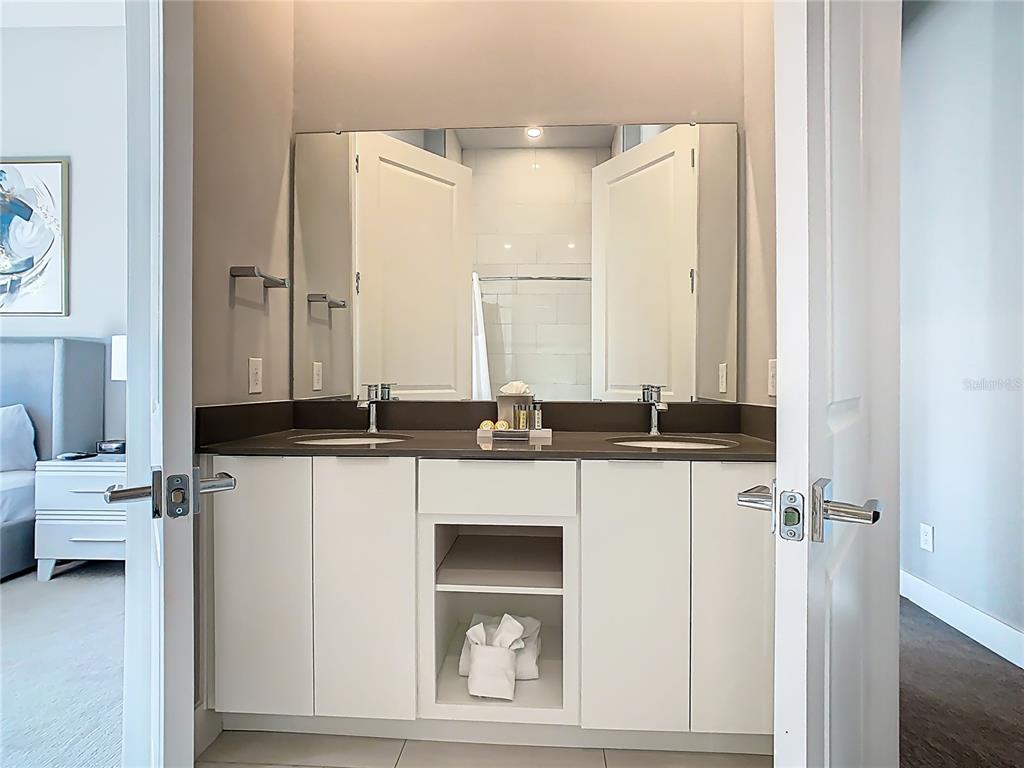 7740 Sandy Ridge Drive, Unit 245 Reunion, FL 34747 - Photo 44 of 57 a bathroom with a sink and a mirror